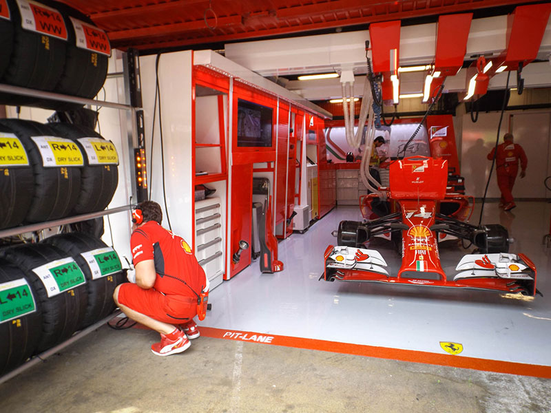Mechanics prepping Fernando Alonso's car before the race