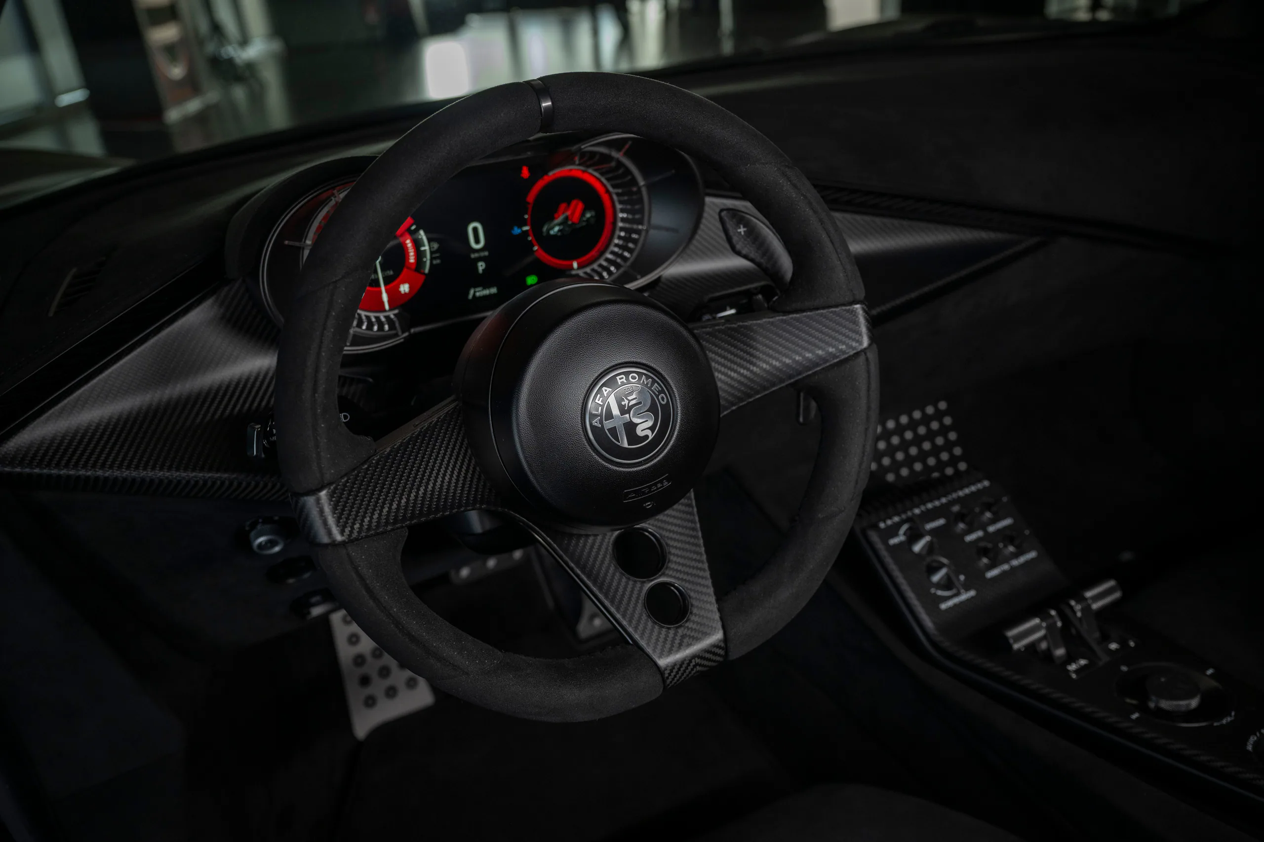 Close-up of a sleek steering wheel and dashboard of a luxury sports car with digital displays.