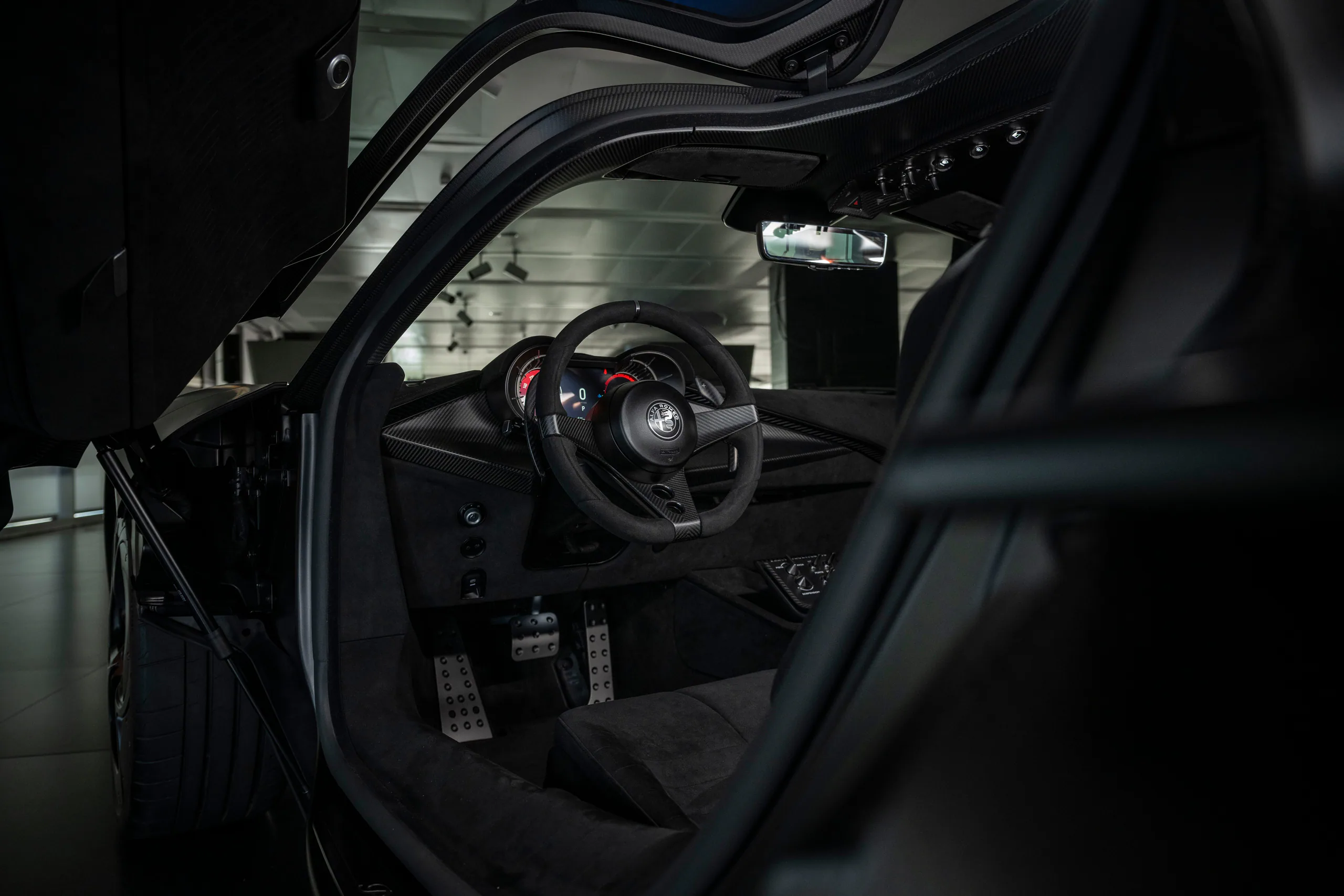 Interior view of a sleek sports car showcasing the steering wheel and dashboard design.