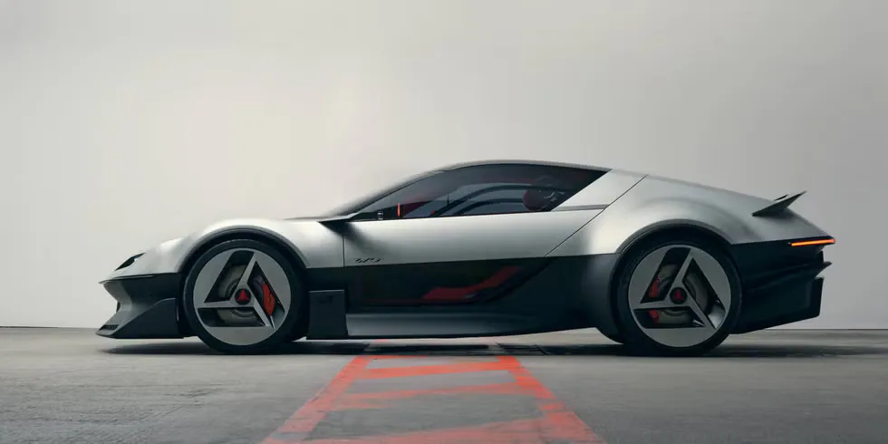 Sleek, futuristic silver sports car with distinctive wheel design parked in a minimalist environment.