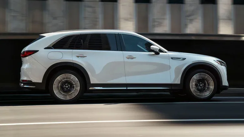 The side profile of a Mazda CX-90 while driving