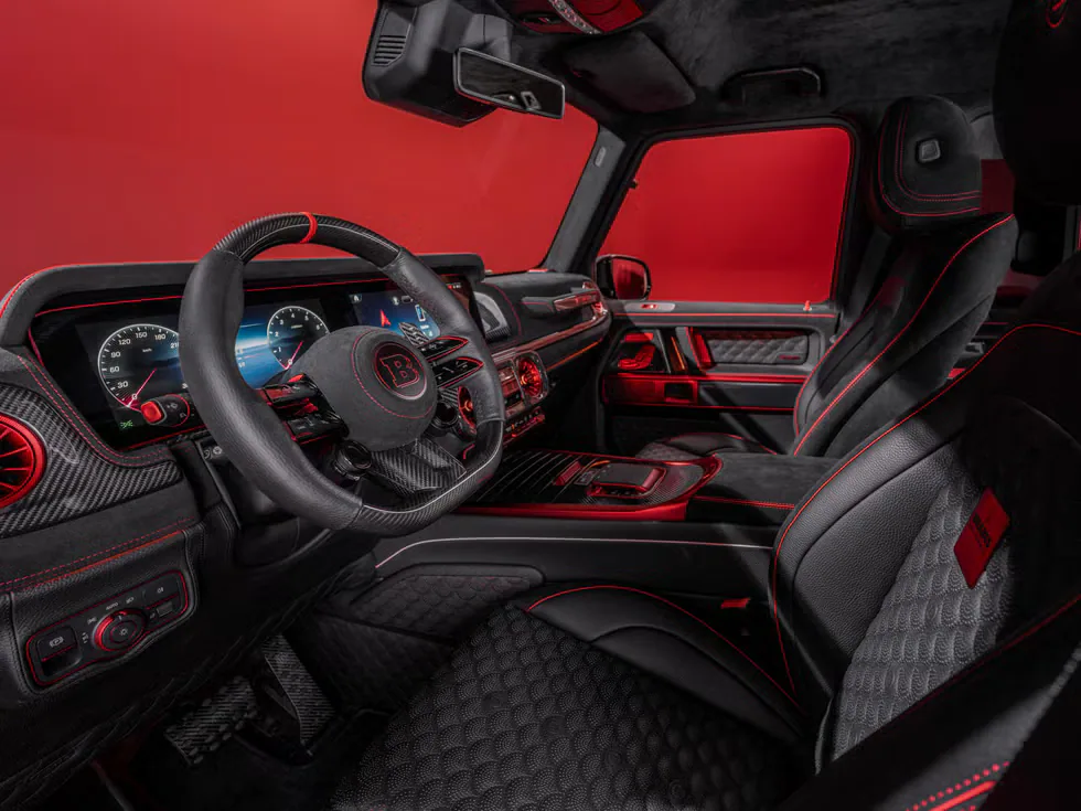 Luxurious car interior featuring carbon accents, red stitching, and advanced digital dashboard against a bold red background.