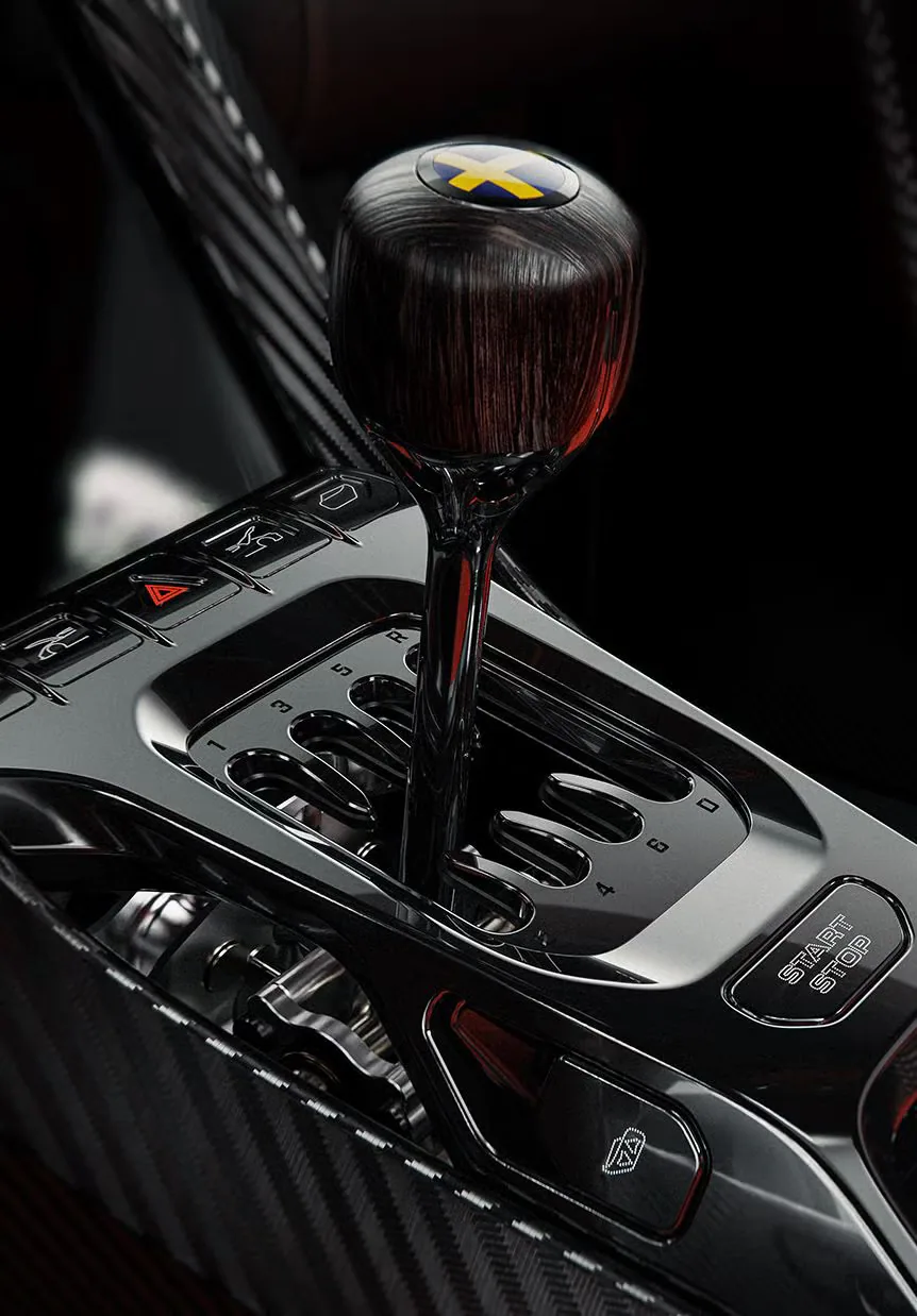 Close-up of a luxury car's gear shifter with a wooden knob and a sleek carbon fiber console.